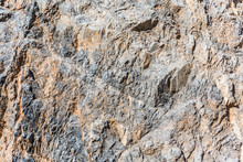 Background And Texture Of Mountain Layers And Cracks In Sedimentary Rock On Cliff Face. Cliff Of Rock Mountain.