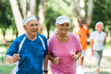 Wall Mural - selective focus of happy retired couple exercising outside