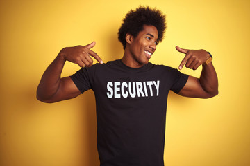 Sticker - American safeguard man with afro hair wearing security uniform over isolated yellow background looking confident with smile on face, pointing oneself with fingers proud and happy.