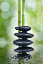 Zen Stones With Green Bamboo On Wooden Table With Green Blur Bokeh Background