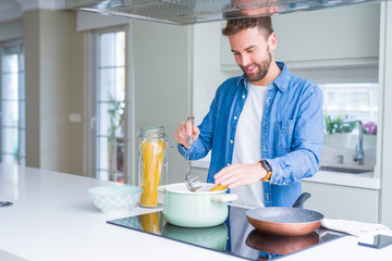 Handsome man cooking pasta at home