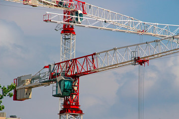 Wall Mural - high tower cranes on a construction site high above the ground