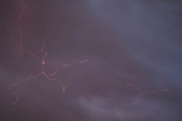 Spectacular image of lightning on a background of gray purple sky, background, wallpaper.