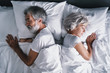 © luengo_ua - Senior family couple sleeping together in bed.