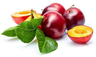 Wall Mural - Fresh plum in cut with green leaf. Fruity still life. Healthy food. Isolated on white background.