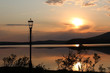 © EllSan - Sunset on the lake with a lantern in the foreground