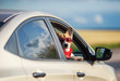 © nataba - funny passenger red corgi puppy dog in sunglasses, he stuck his pretty face  and paws from the car window during mja suburban summer trip