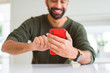 Close up of man using smartphone smiling