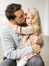 Mid Adult Man Kissing His Daughter On The Cheek