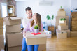 © Krakenimages.com - Young beautiful couple in love moving to new home, holding cardboard boxes very happy and cheerful for new apartment