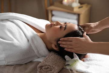 Wall Mural - Beautiful Asian woman getting head massage in spa salon