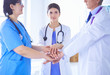 © lenets_tan - Group of doctors putting their hands together. Close-up