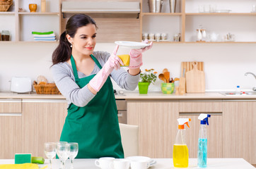 Young female contractor doing housework