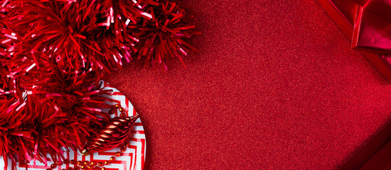 Wall Mural - Merry christmas and happy new year red background.top view of tinsel,gift box,ball,ribbon decorate on sparkling table.holiday celebration greeting card.banner panoramic mockup for display of design.