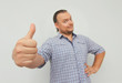 © exienator - Young man with checkered shirt shows thumbs up. Hipster freelancer.
