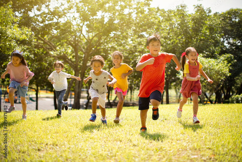 Multi-ethnic group of school children laughing and running Stock Photo ...