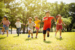 © Tom Wang - Multi-ethnic group of school children laughing and running