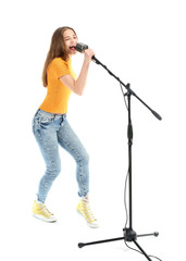 Wall Mural - Teenage girl with microphone singing against white background