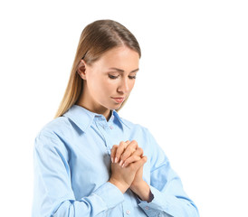 Wall Mural - Religious young woman praying on white background