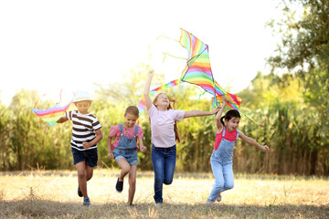 Wall Mural - Little children flying kites outdoors