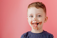 Little Boy Eating Chocolate. Cute Happy Boy Smeared With Chocolate Around His Mouth. Child Concept.