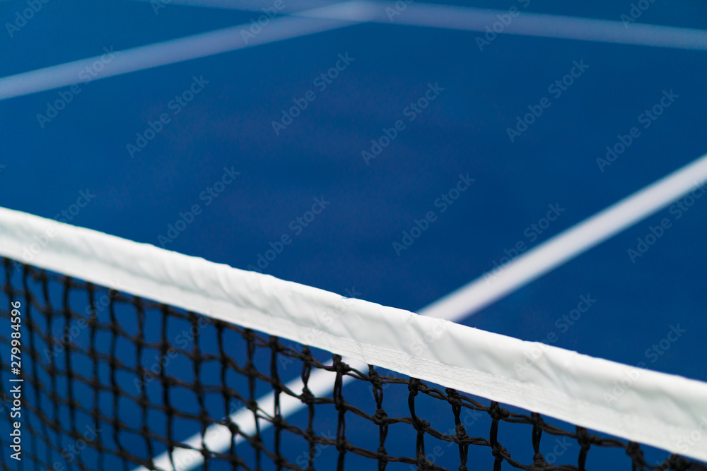 diagonal net of tennis with white stripe in blue hard court, tennis compettion concept - obrazy, fototapety, plakaty 