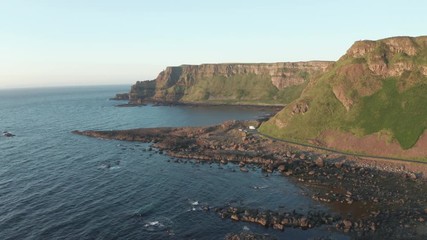 Wall Mural - Aerial Flight view of  Giant's Causeway rocks cliff area during summer sunset time Northern Ireland