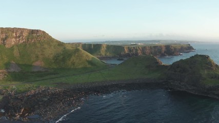 Wall Mural - Aerial Flight view of  Giant's Causeway rocks cliff area during summer sunset time Northern Ireland