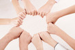 © DragonImages - Close-up of group of people hiding their fingers and making circle from fists over white background