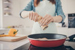 Cropped closeup photo of neat arms wife put different spices into tasty dish wear dotted apron