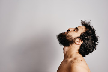 bearded man gesturing with white background