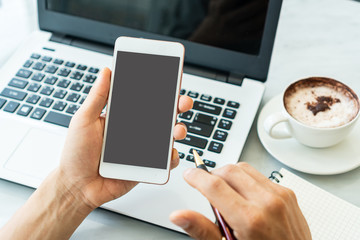 Wall Mural - Businessman using mobile in a cafe.close up