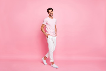 Poster - Full length body size view portrait of his he nice attractive lovely content cheerful cheery successful guy walking holding hands in pockets isolated over pink pastel background