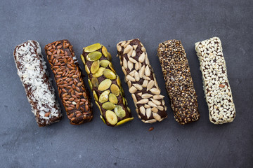 Chocolate energy protein bars with nuts, seeds, dry fruits. Healthy dietary snack. Vegan dessert. Chia, flax seeds, coconut, sesame, pumpkin, sunflower seeds.