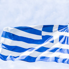 Greek flag and cloudy sky in summer day, politics of Europe