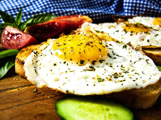 Sandwiches with fried egg, cucumber, tomatoes and basil. Healthy breakfast