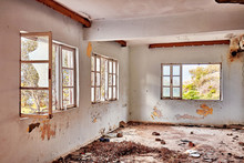 Interior Of An Old Abandoned Ruin House With White Cracked Walls And Broken Window Frames