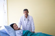 © Kodokan - Senior doctor smile in uniform with  his woman patient