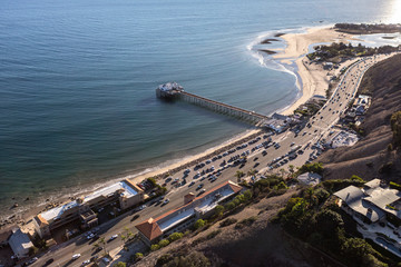 Aerial view of Pacific Coast Highway and scenic Malibu Pier in Los Angeles County, California.