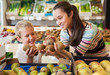 © JackF - mother with little boy buying kiwi at store