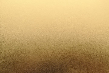 Shiny yellow metallic gold leaf foil texture background