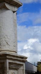 White column close up view by blue cloudy sky