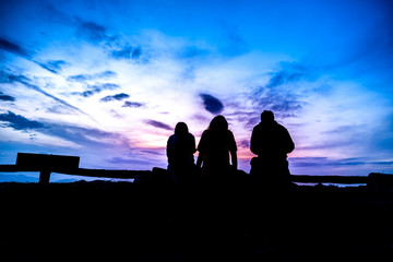 Wall Mural - Silhouette of thai people on top at Doi Samer Dao at sunrise, Nan, Thailand.