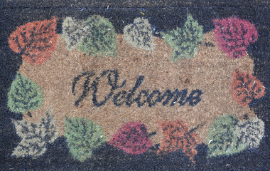 Welcome text on doormat background.