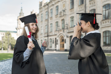 Wall Mural - Students taking photo of each other at graduation