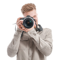 Wall Mural - Young male photographer on white background