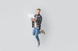 © Pixel-Shot - Jumping young man with laptop on light background