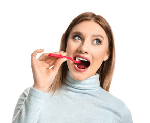 Wall Mural - Woman cleaning teeth on white background