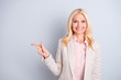 © deagreez - Portrait of her she nice-looking attractive stylish elegant content wavy-haired lady expert pointing forefinger aside ad advert solution isolated on light white gray pastel background