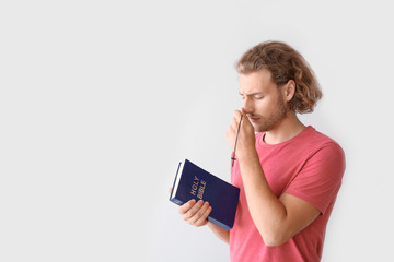 Wall Mural - Religious young man praying on white background